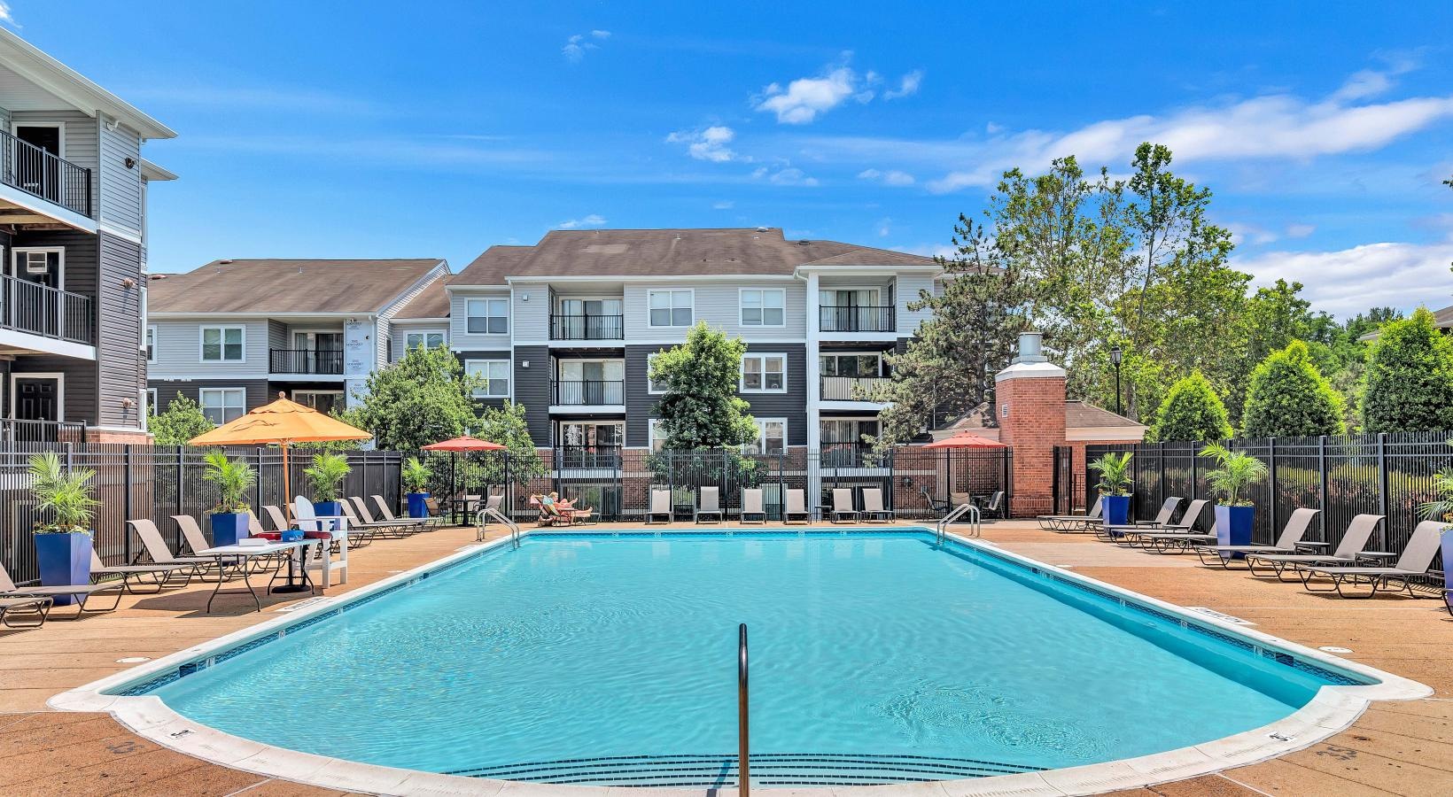 Relax and unwind poolside a swimming pool in a backyard