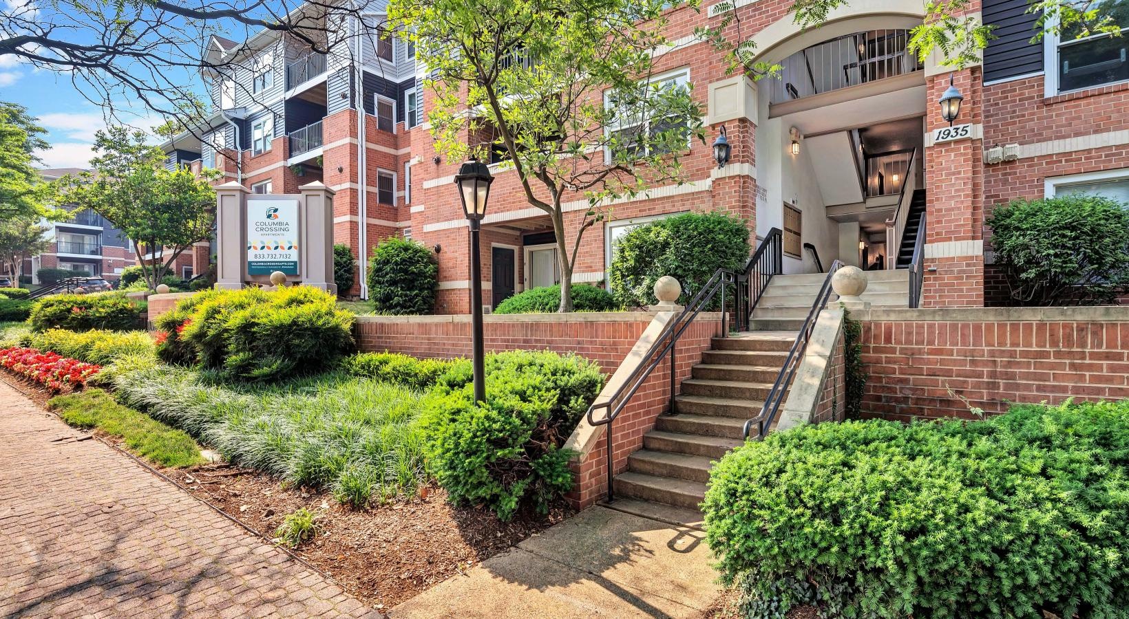 Settle into comfort at Columbia Crossing a brick building with stairs and bushes