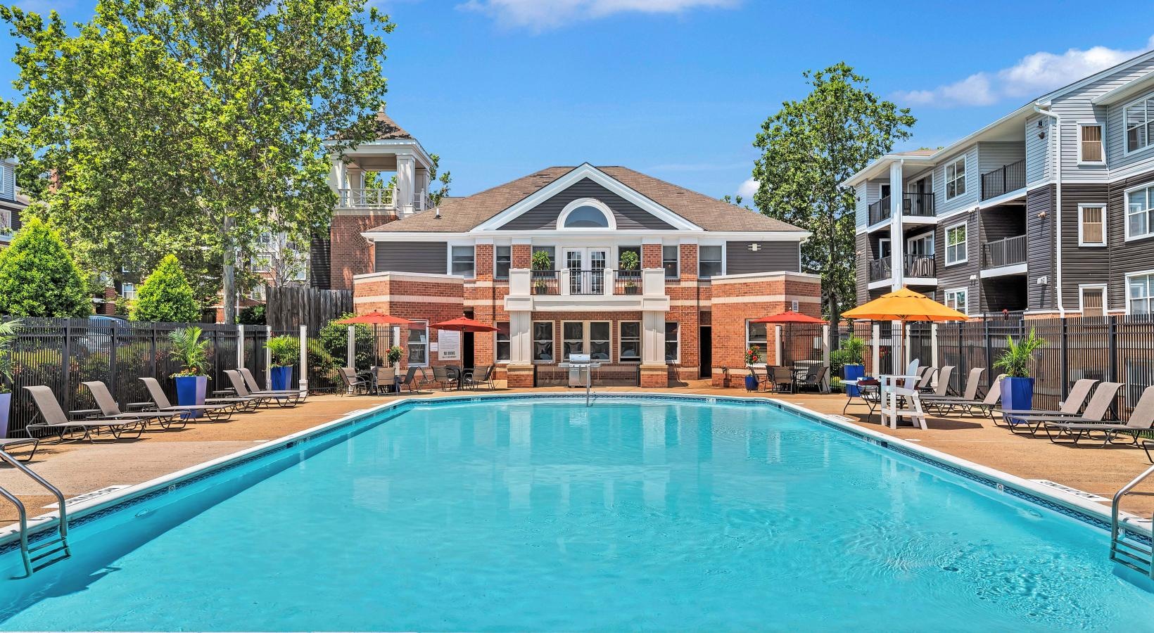 Relax and unwind poolside a swimming pool in a backyard