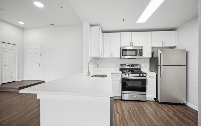 Newly renovated apartment with white cabinetry, updated flooring and stainless steel appliances. 